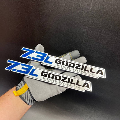 Premium 7.3L Godzilla King Ranch exterior car badge shown in brushed metal style
