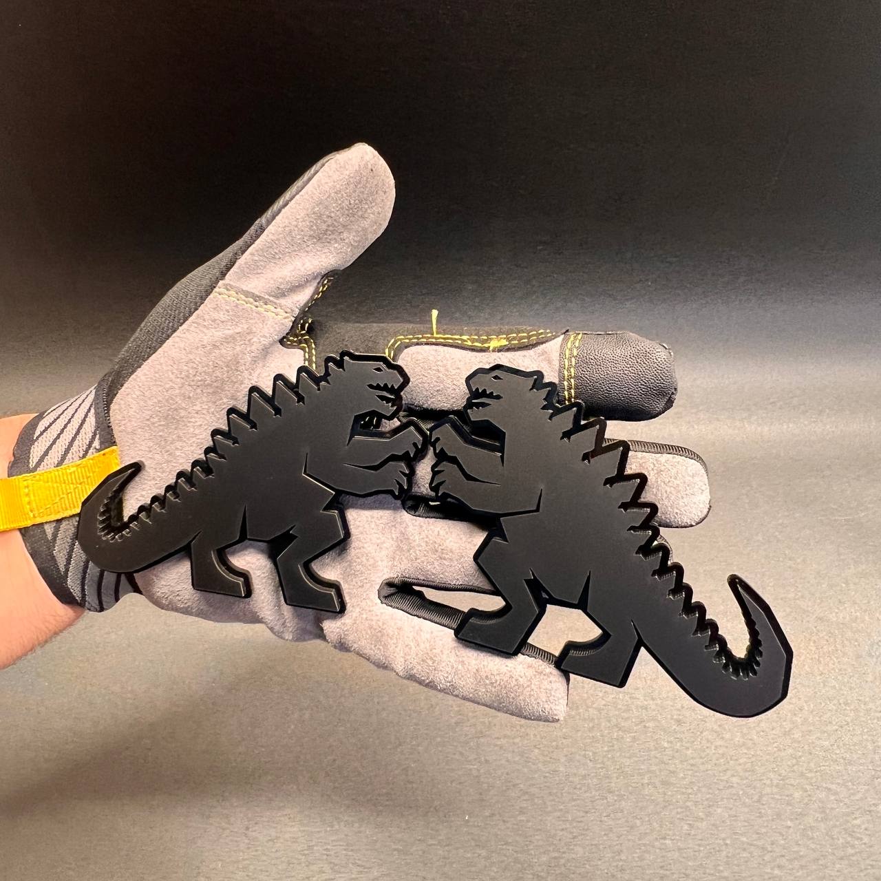 Godzilla inspired black acrylic car emblem with detailed dinosaur silhouette for cars, trucks, and SUVs.