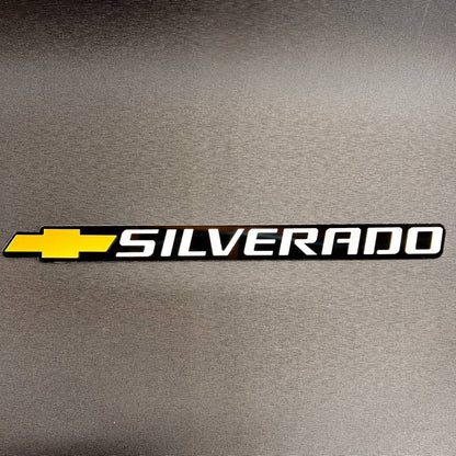 Chevy Gold Bowtie Silverado tailgate car badge in black and white finish.