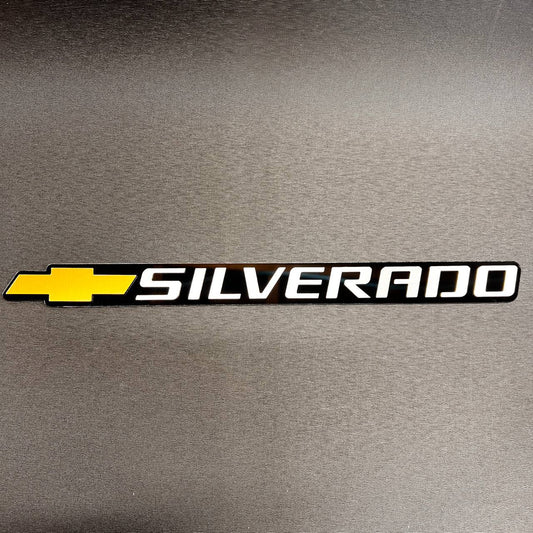 Chevy Gold Bowtie Silverado tailgate car badge in black and white finish.