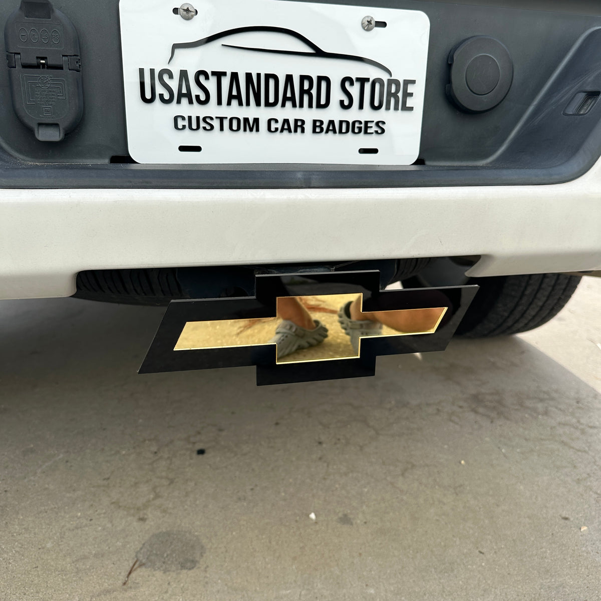 Gold Chevy emblem hitch receiver cover for pickup truck exterior