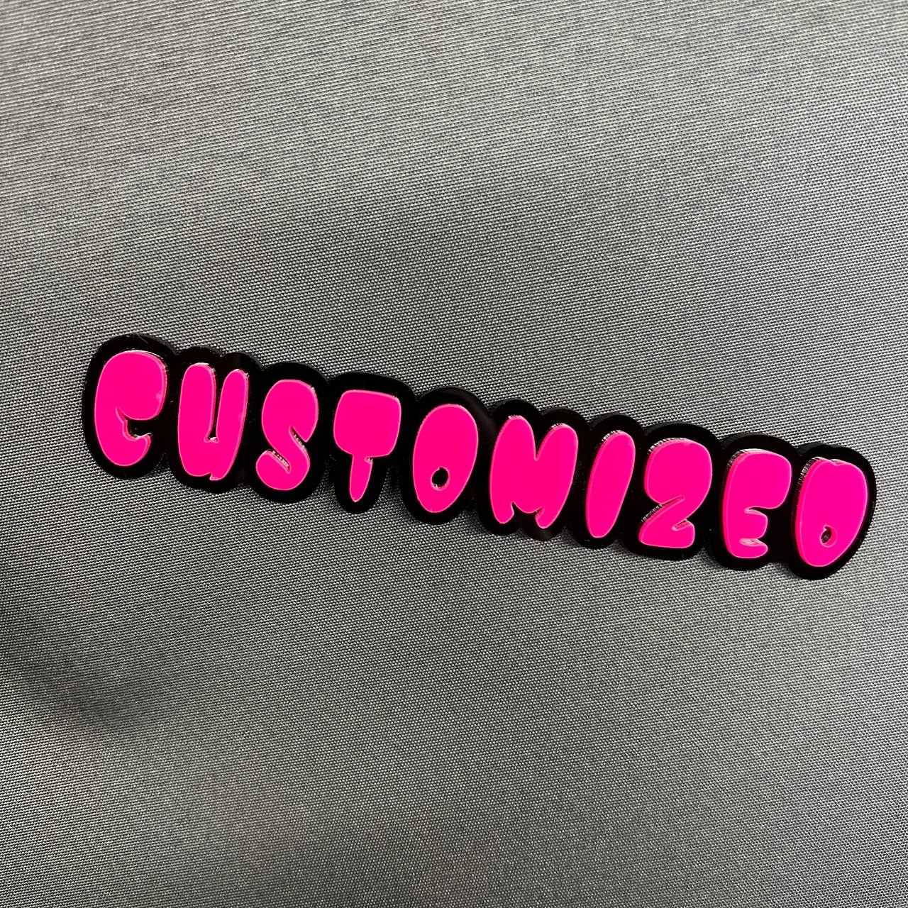 Custom 3D car badge with bold pink lettering and black backing
