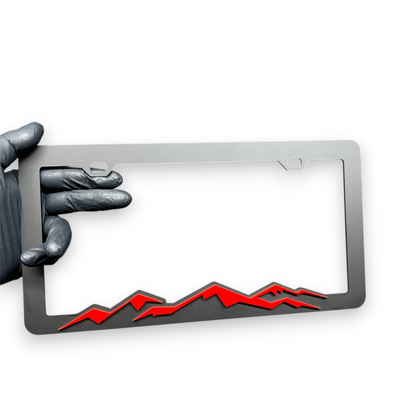 Decorative mountain license plate frame with sporty offroad inspired design