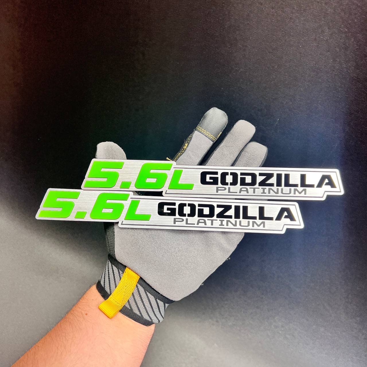 Premium Godzilla Platinum 5.6L exterior text emblem displayed in a gloved hand