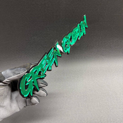 Green Goblin Spider-Man villain inspired car text badge in green and black, decorative aftermarket emblem for Chevrolet Silverado and GMC Sierra trucks.