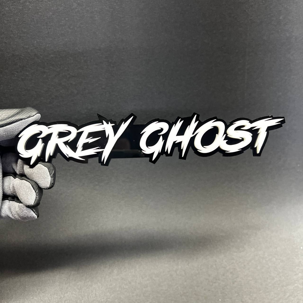 White and black Grey Ghost automotive emblem with aggressive script design for custom performance car styling