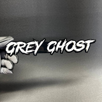 White and black Grey Ghost automotive emblem with aggressive script design for custom performance car styling