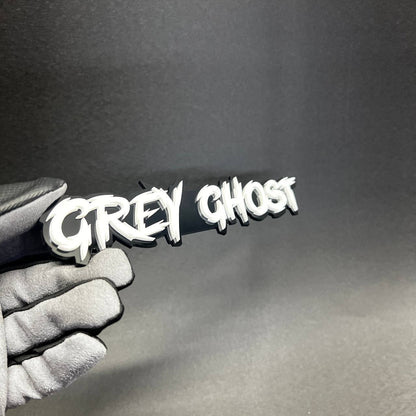 Custom Grey Ghost acrylic Car Badge Fender Emblem with bold white lettering and black backing for Dodge Charger style builds.