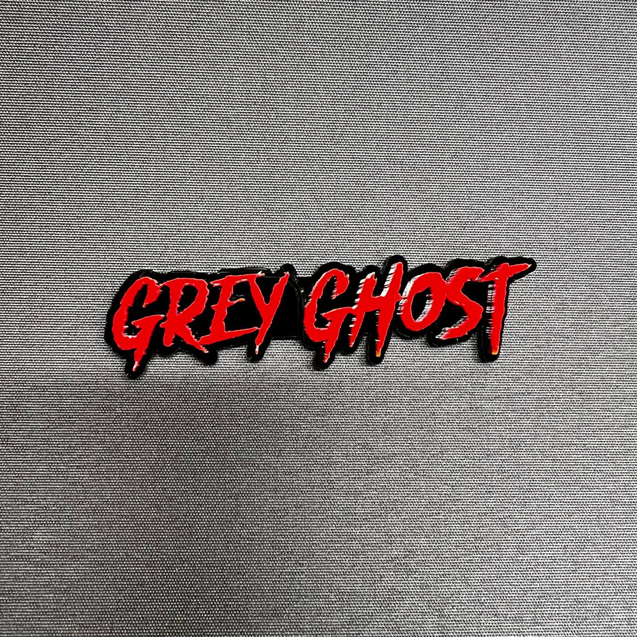 Grey Ghost custom text car badge emblem in red and black acrylic for truck fender and tailgate styling on Ford F150 performance build