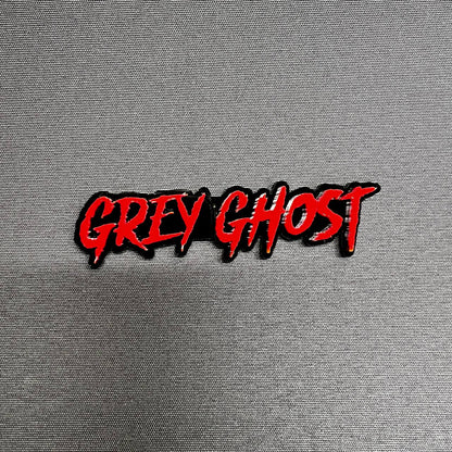 Grey Ghost custom text car badge emblem in red and black acrylic for truck fender and tailgate styling on Ford F150 performance build