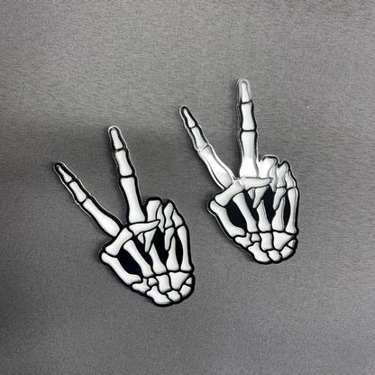 Bone hand car badge emblem with bold black and white design.