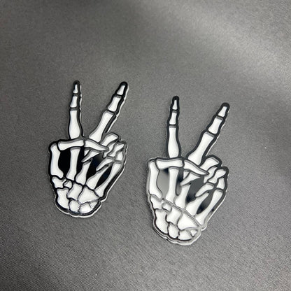 Hang Loose Skeleton Hand car badge in black and white acrylic style.