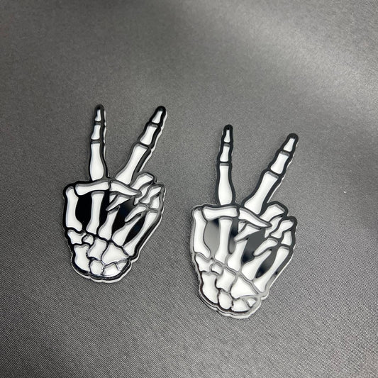 Hang Loose Skeleton Hand car badge in black and white acrylic style.