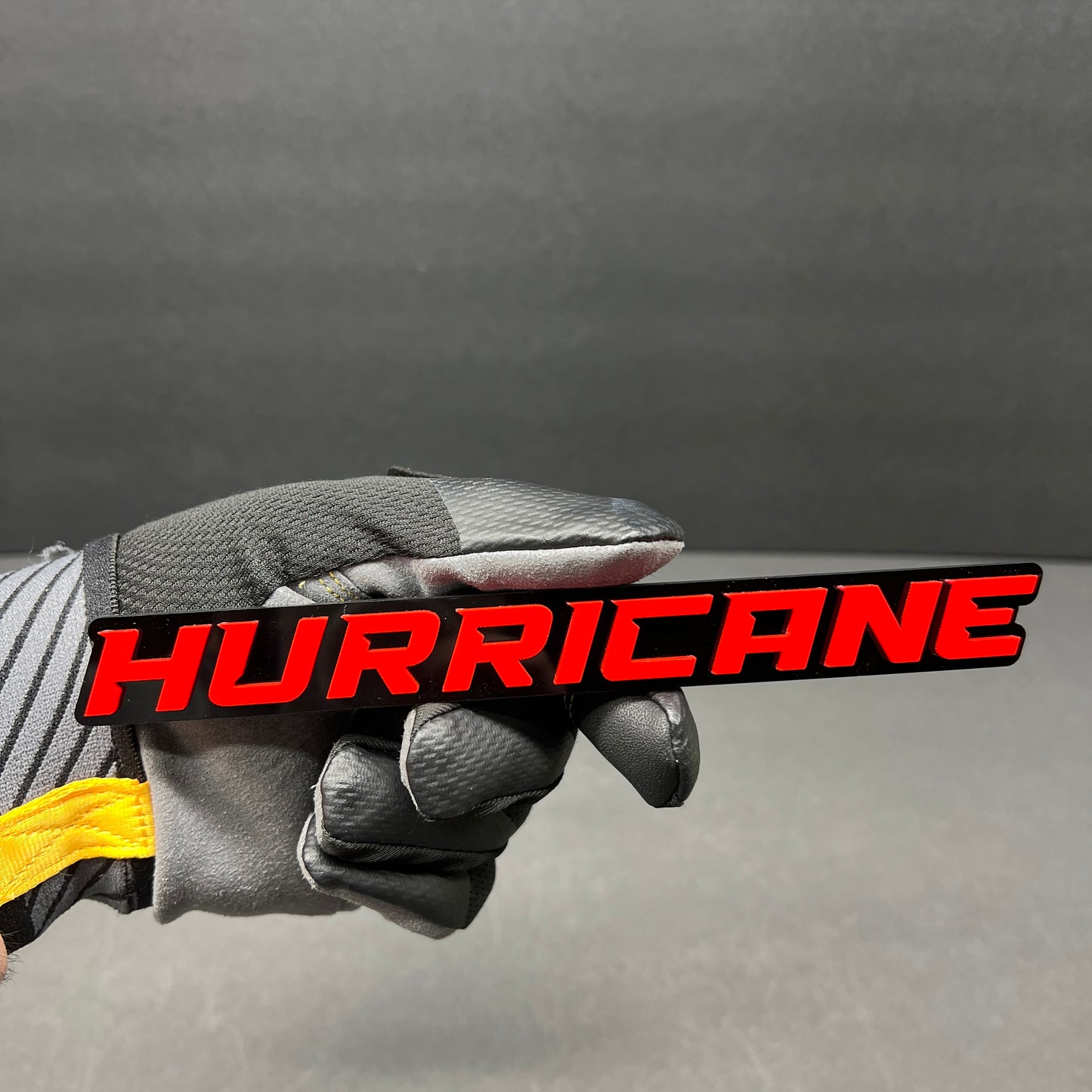 Hurricane custom text car badge in white on gloss black with automotive 3M adhesive.