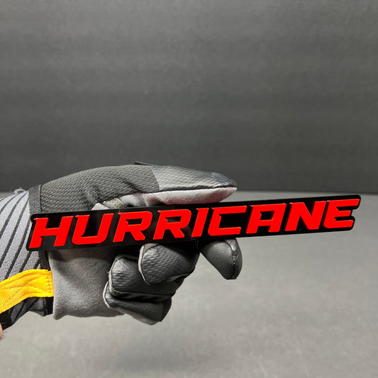 Hurricane custom text car badge in white on gloss black with automotive 3M adhesive.