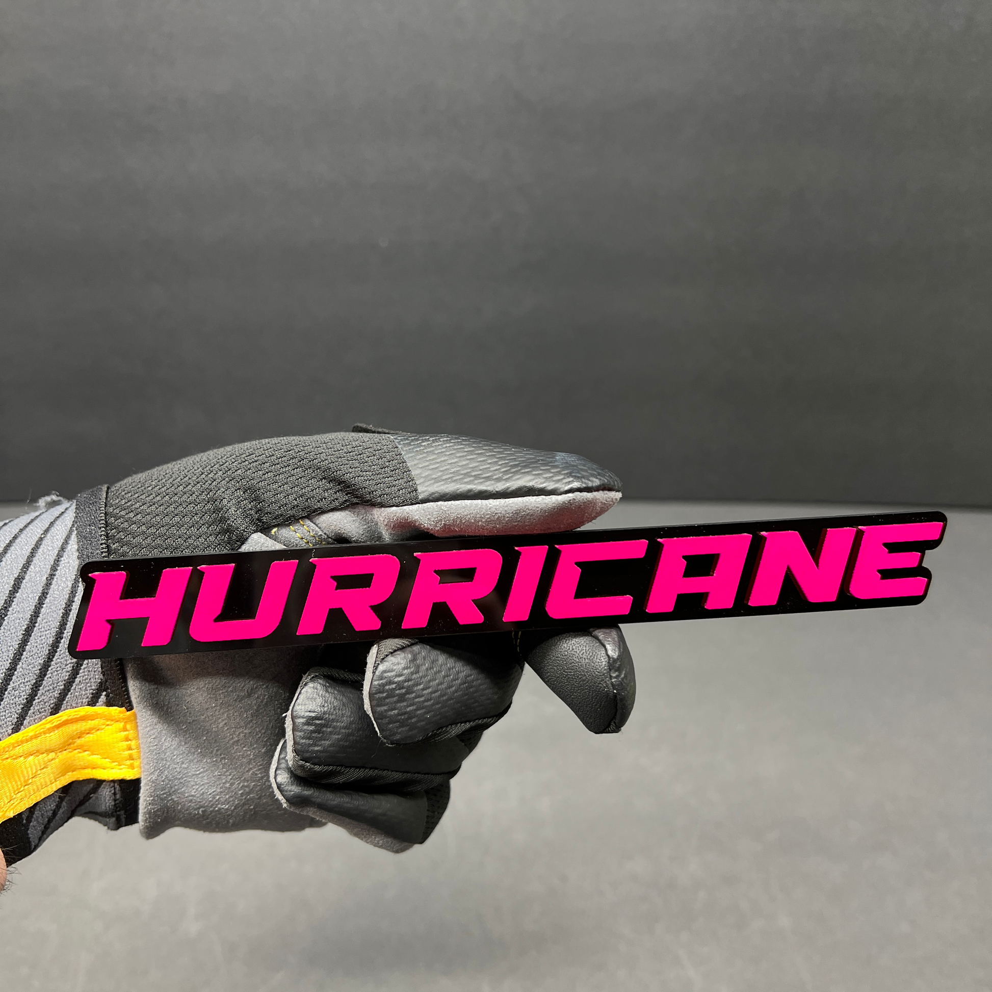 Hurricane car badge with modern racing-inspired lettering for exterior customization.