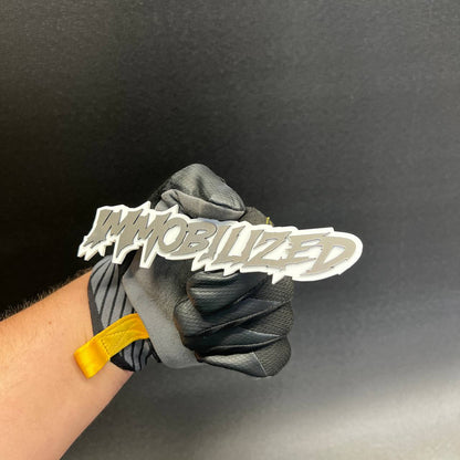 Immobilized custom automotive badge for hood, tailgate, grille, or fender installation