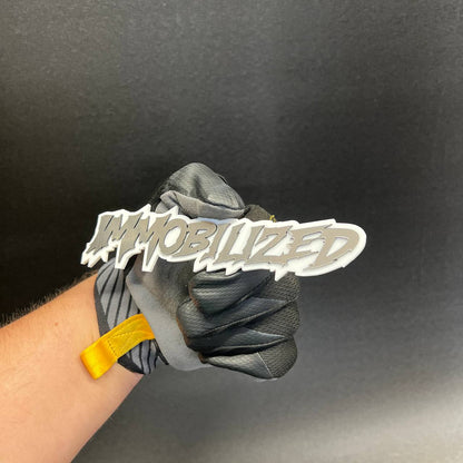 Performance inspired Immobilized text badge with reflective silver finish and white border