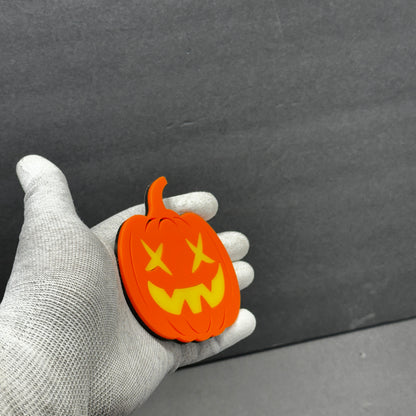 Bright orange Halloween vehicle badge with layered yellow pumpkin face