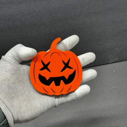 Spooky orange car emblem pumpkin badge with black face details