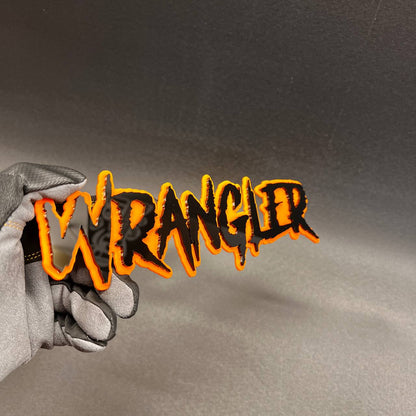 Custom Wrangler text badge with automotive-grade 3M adhesive backing.