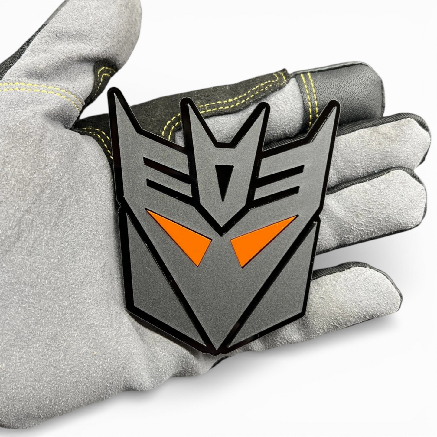 Custom transformer style emblem for Toyota Tundra tailgate, bold black acrylic badge with red eye design