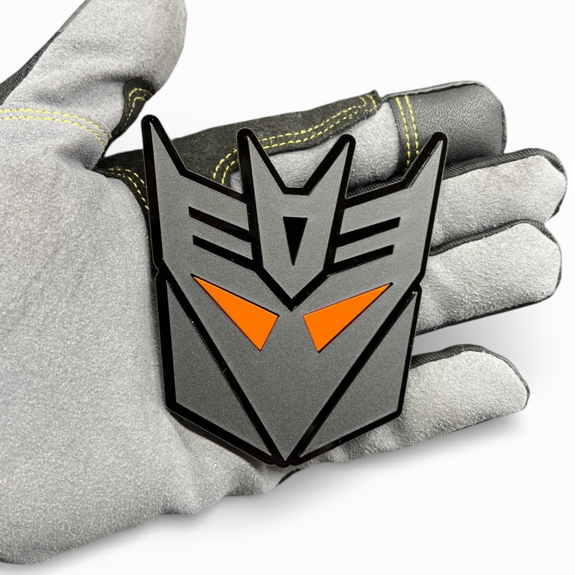 Custom transformer style emblem for Toyota Tundra tailgate, bold black acrylic badge with red eye design