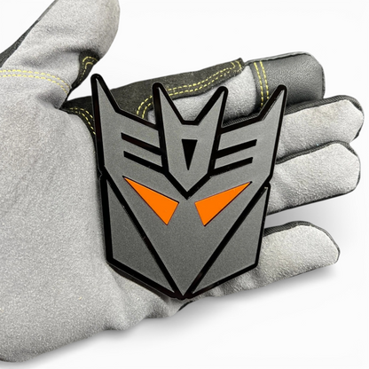 Custom transformer style emblem for Toyota Tundra tailgate, bold black acrylic badge with red eye design