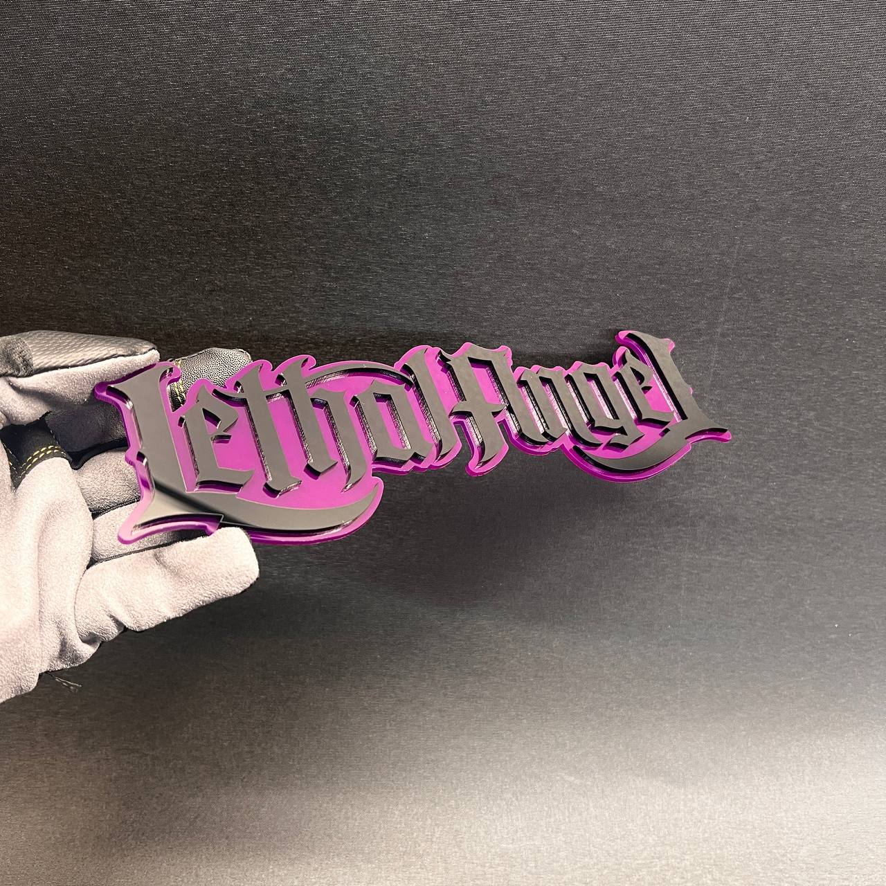 Custom Lethal Angel text car badge with layered pink and black finish