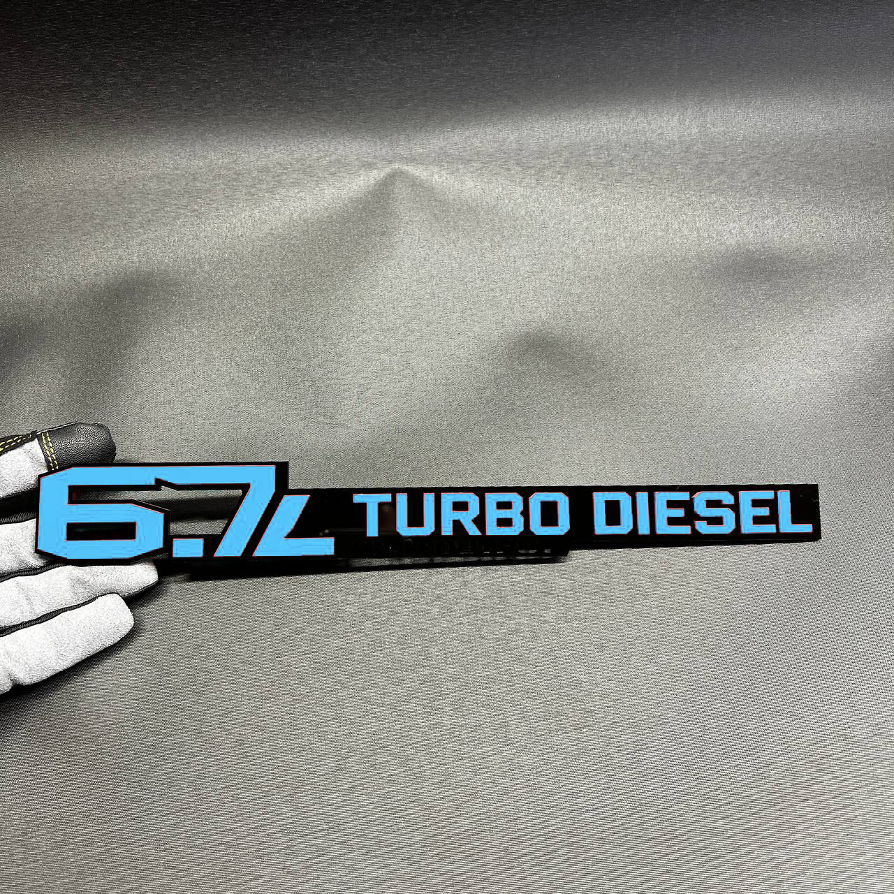 6.7L Turbo Diesel High Output acrylic badge in red and black for heavy duty diesel truck styling.