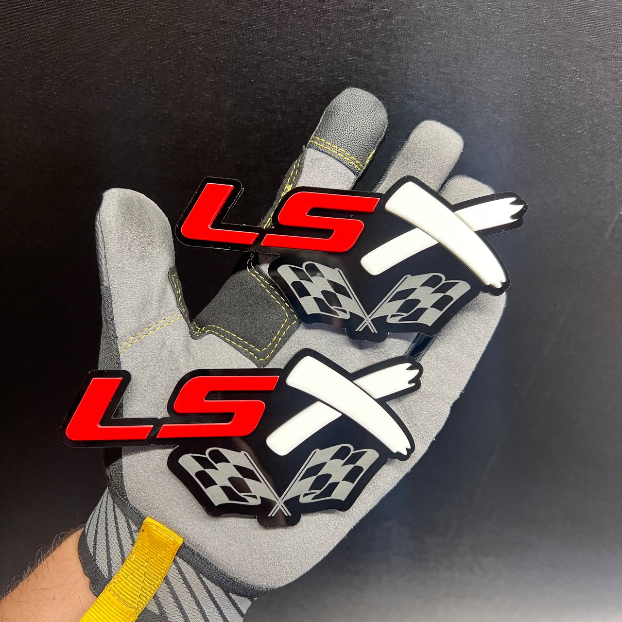 LSX racing flag car badge with red lettering and crossed white racing flags