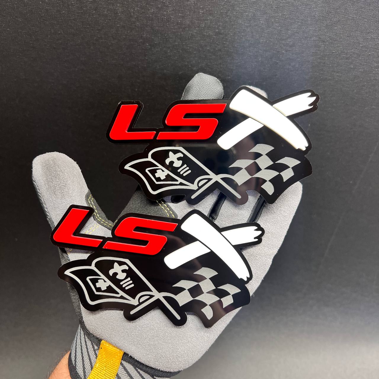 LSX racing flag car badge with red LS letters and white crossed flags