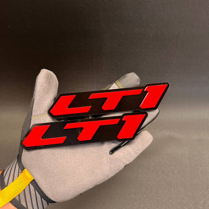 Red and black LTI car badge fender emblem set with bold raised lettering