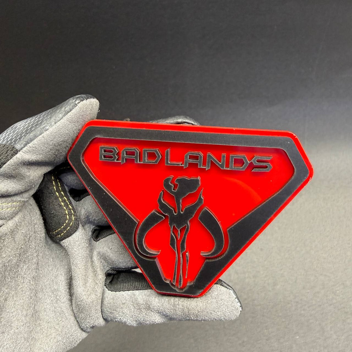 Red and black Badlands Mythosaur-inspired automotive emblem with a bold skull design, ideal for custom Ford Bronco Badlands styling.