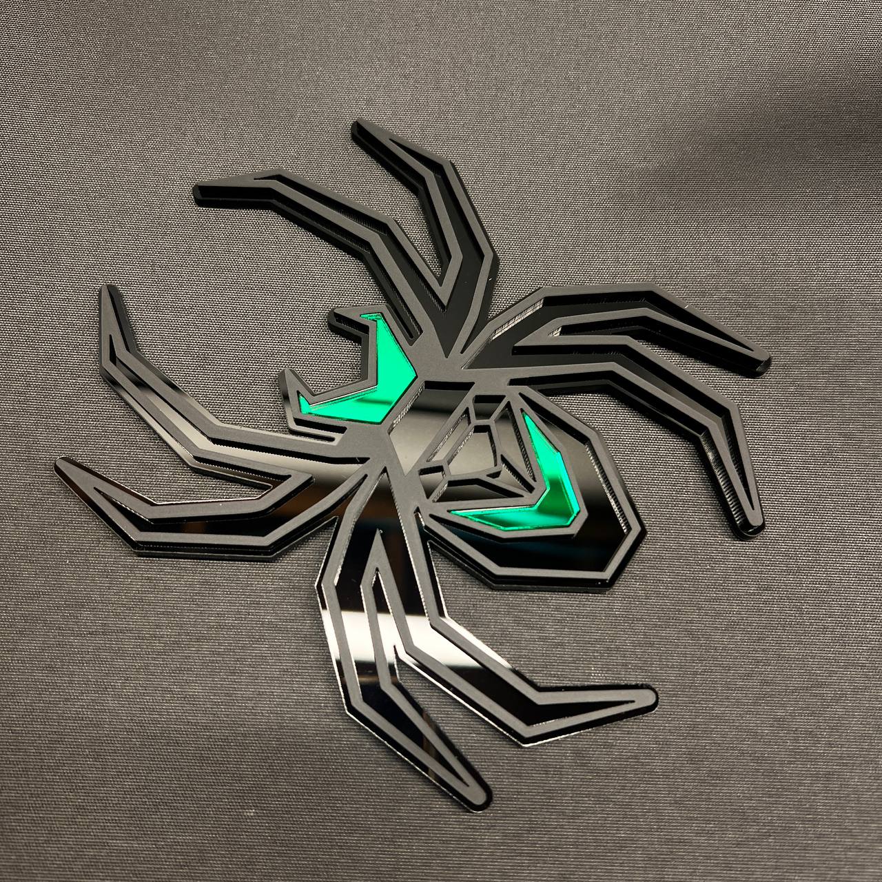Matte black spider car badge with green details designed as a custom trailer hitch cover.