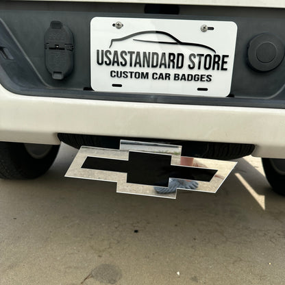 Silver and black Chevy Bowtie hitch cover installed on rear truck hitch
