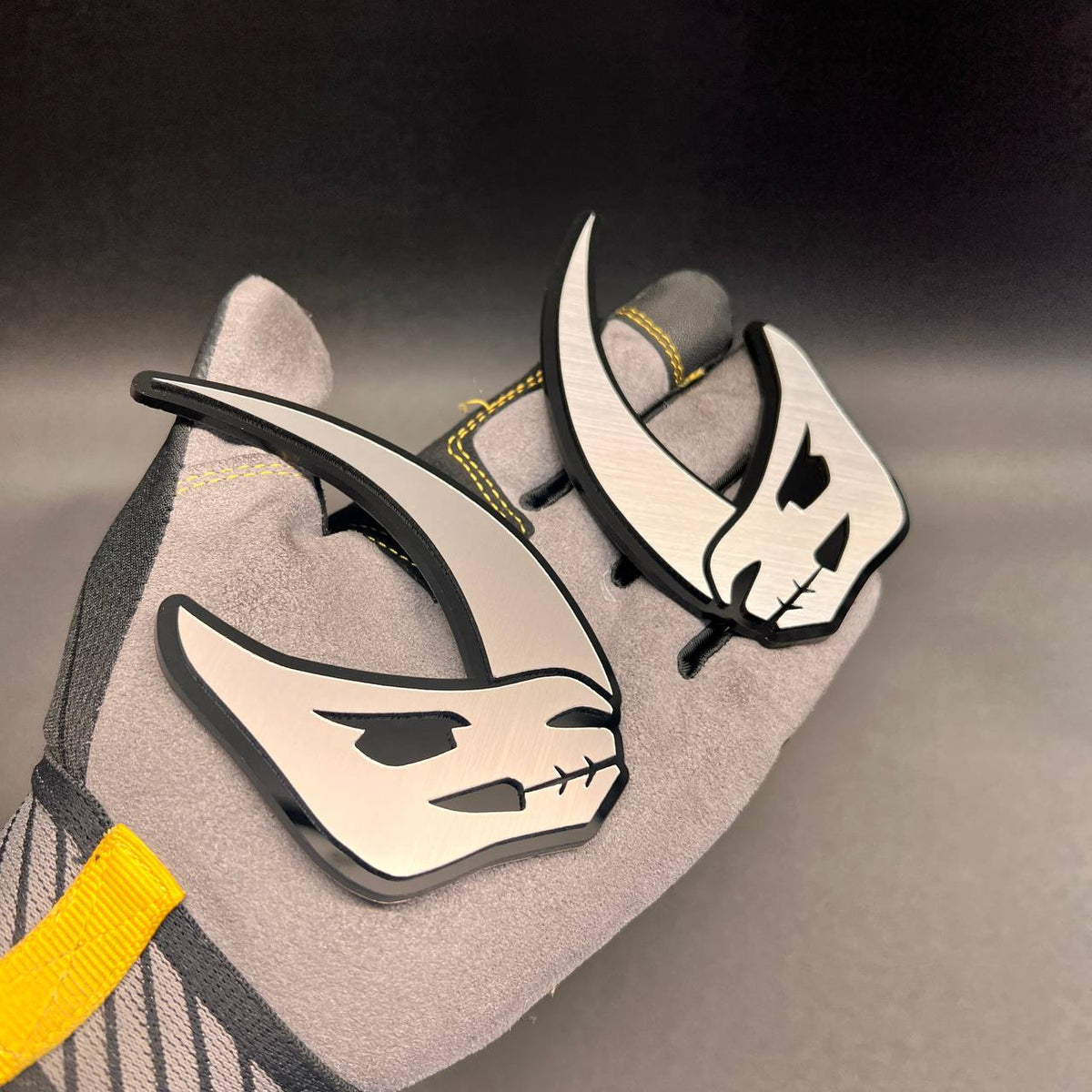 Mudhorn automotive emblem featuring a bold horned design in brushed silver and black