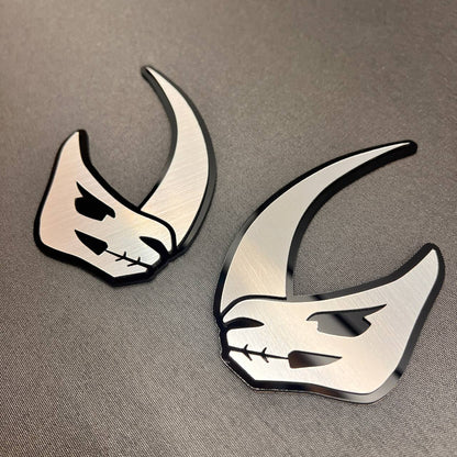 Brushed metal Mudhorn vehicle badge with black layered outline