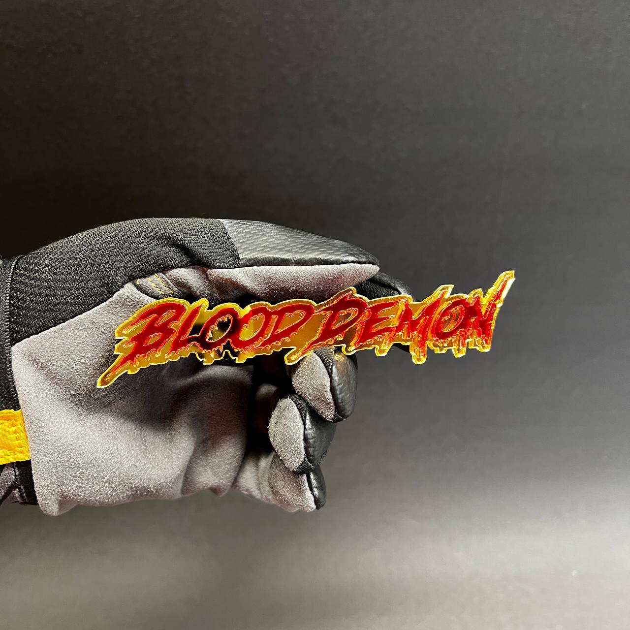 Custom Blood Demon text badge in red mirror acrylic with gold outline for truck and muscle car styling