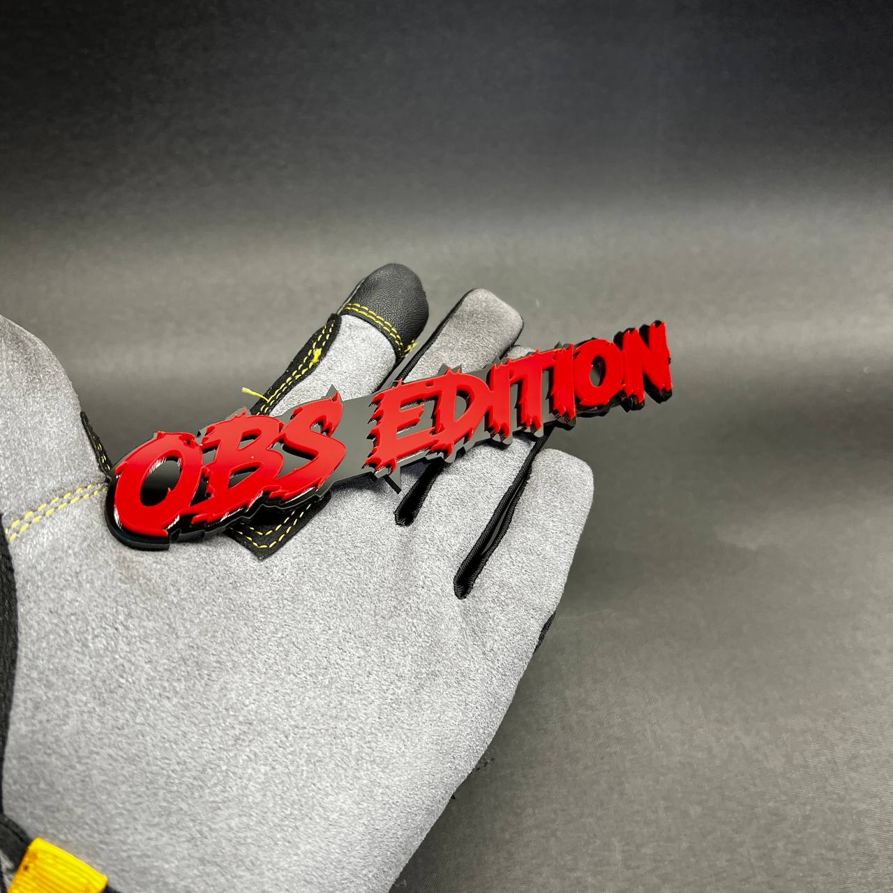 Custom OBS Edition automotive emblem in red with black outline for vehicle fender or tailgate.