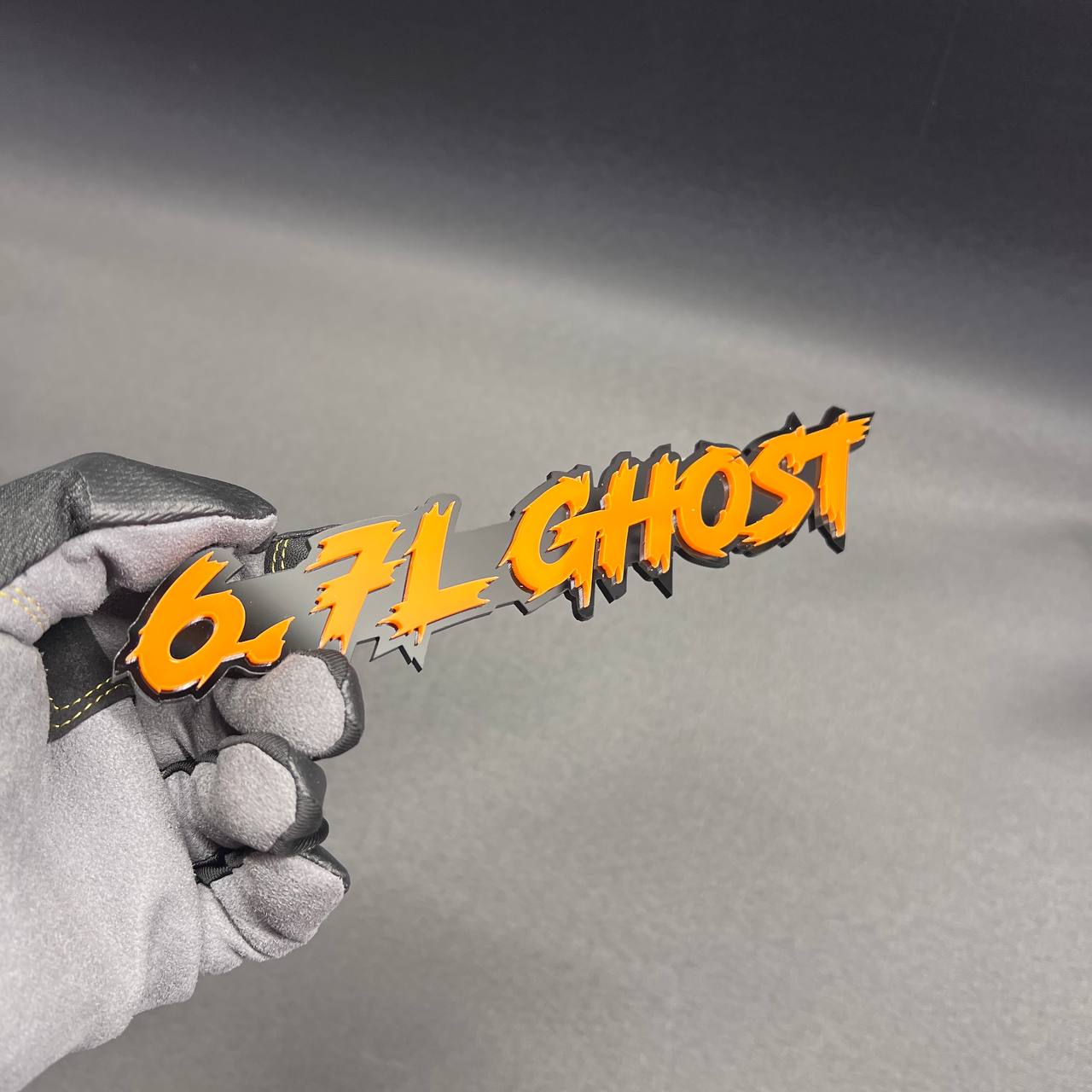 Aggressive 6.7L GHOST truck badge with layered orange top and black base design