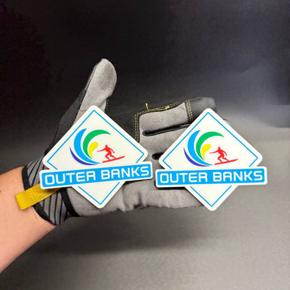 UV printed Outer Banks side badge with blue green yellow wave and red surfer