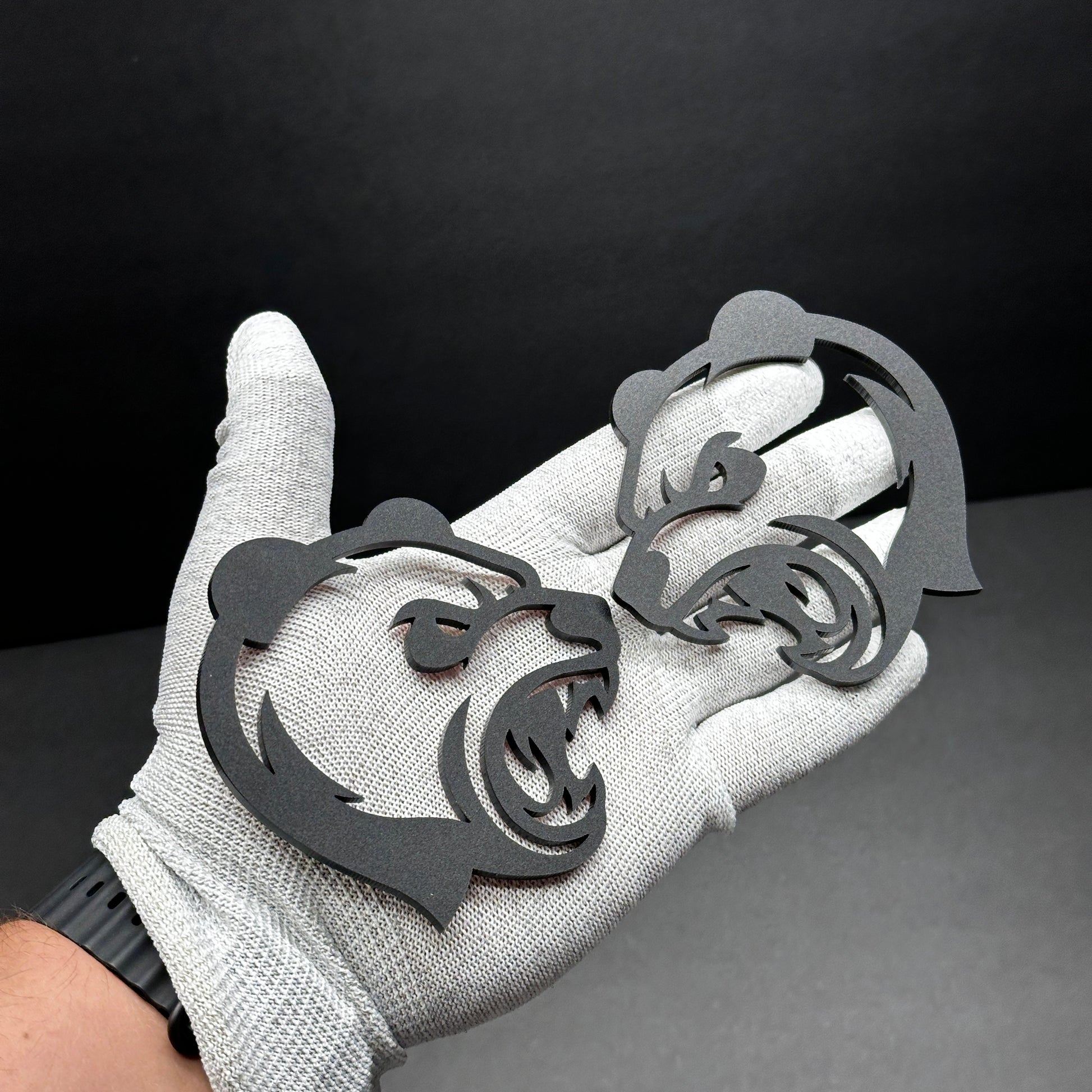 Panda head badge pair shown as custom vehicle fender emblem