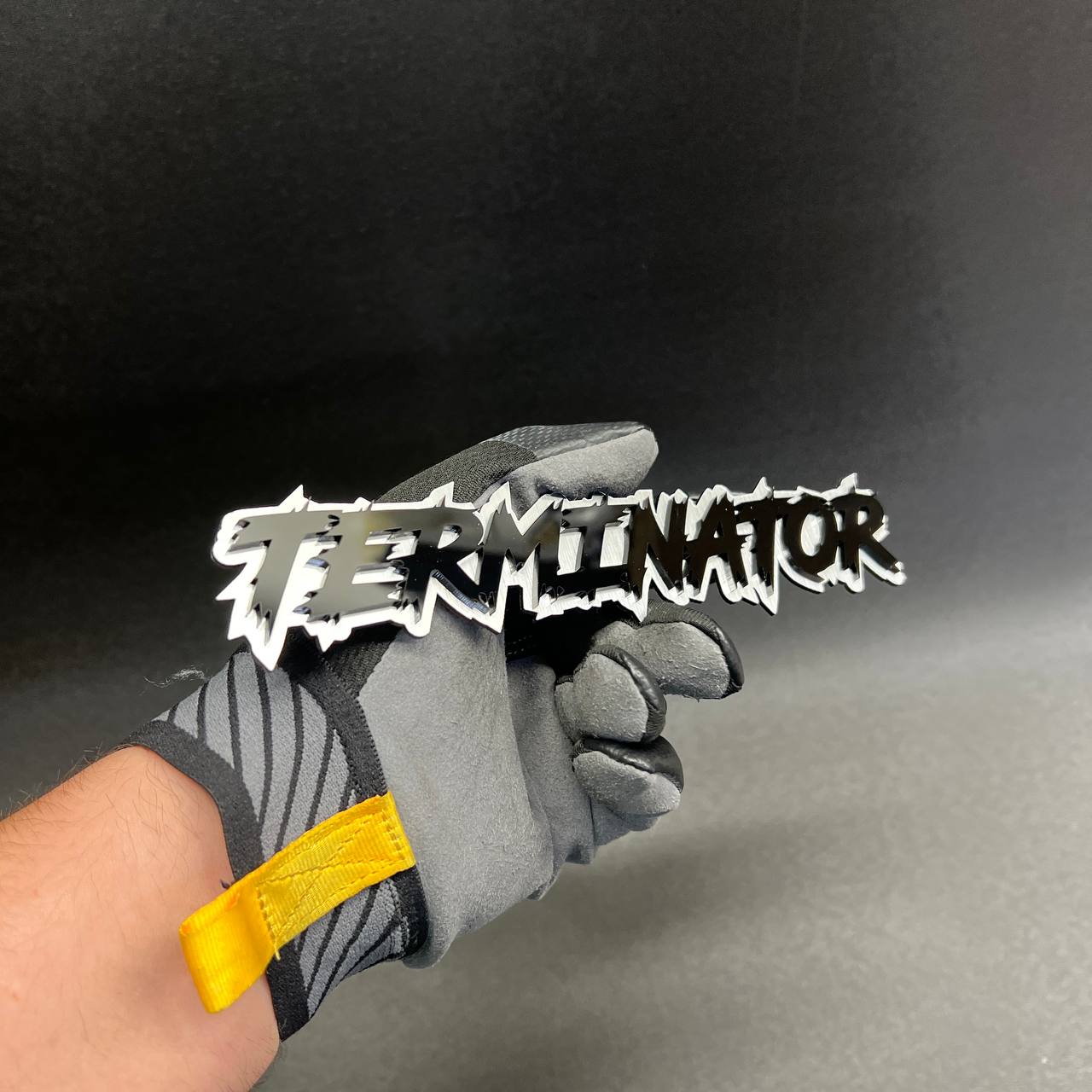 Laser cut acrylic TERMINATOR lettering emblem with bold jagged font styling for custom cars