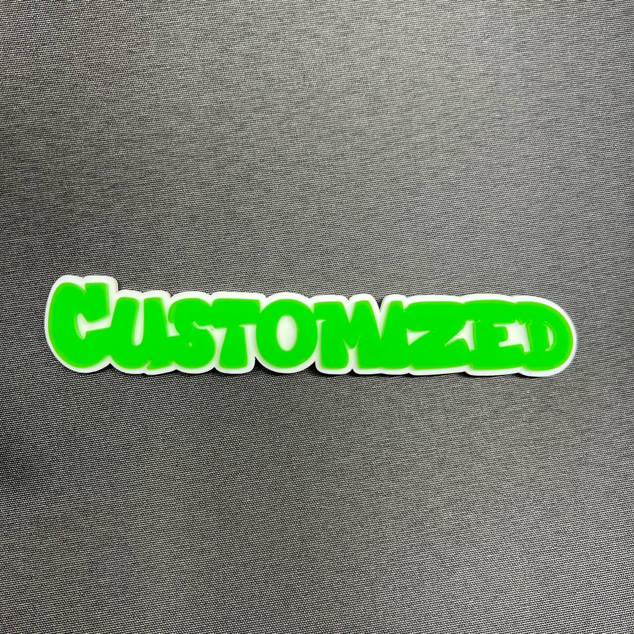 Bright green custom text badge with white backing for vehicle accessories