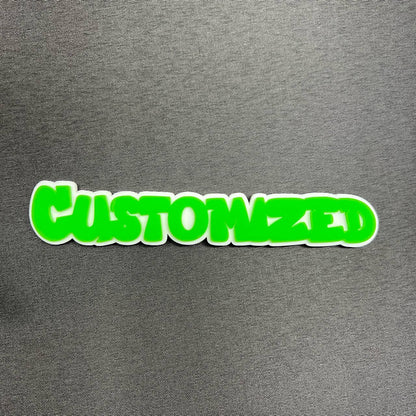 Bright green custom text badge with white backing for vehicle accessories