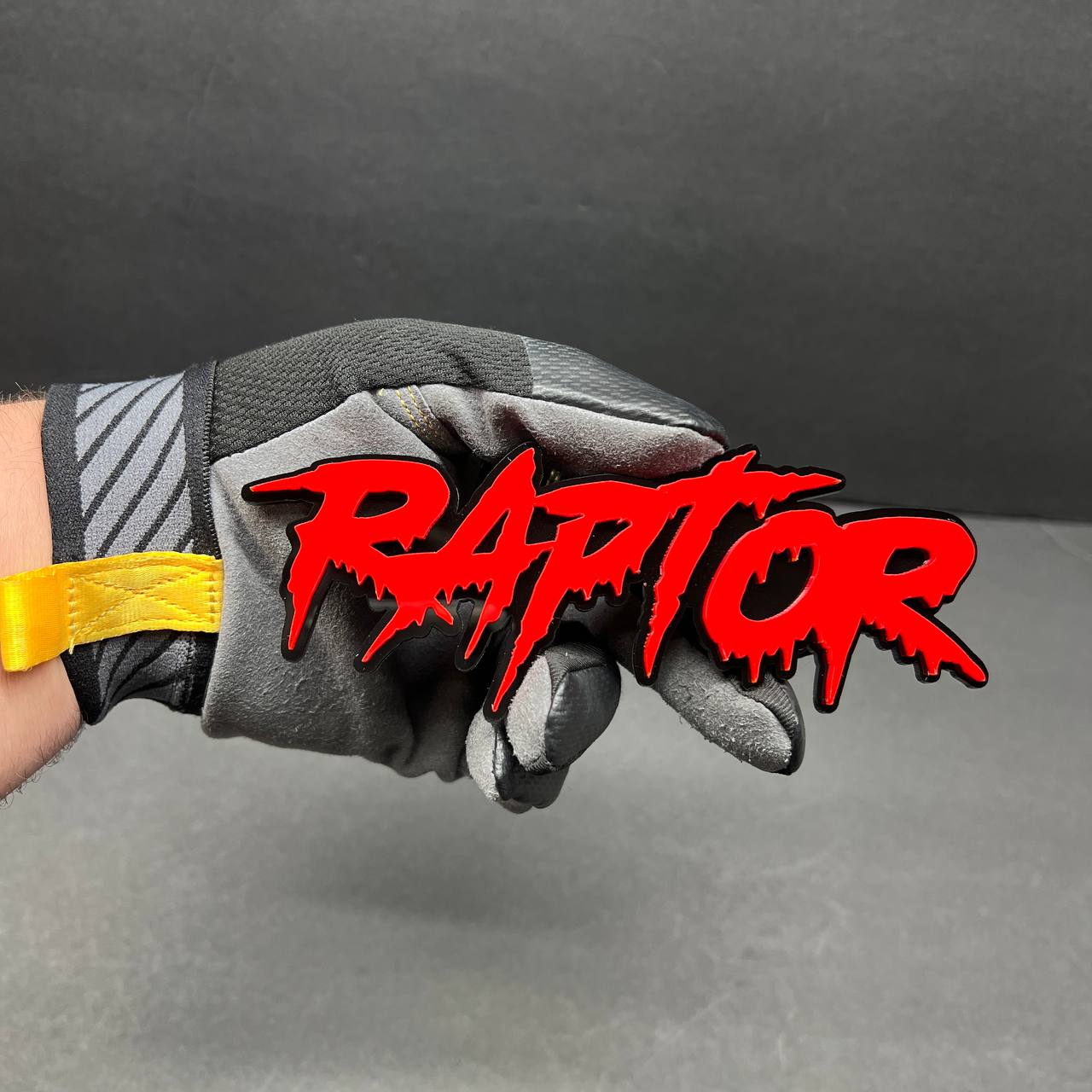 Custom red and black acrylic car emblem with horror style lettering