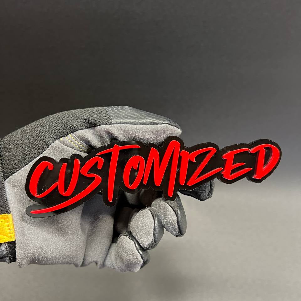 Custom car badge made with red letters on black backing