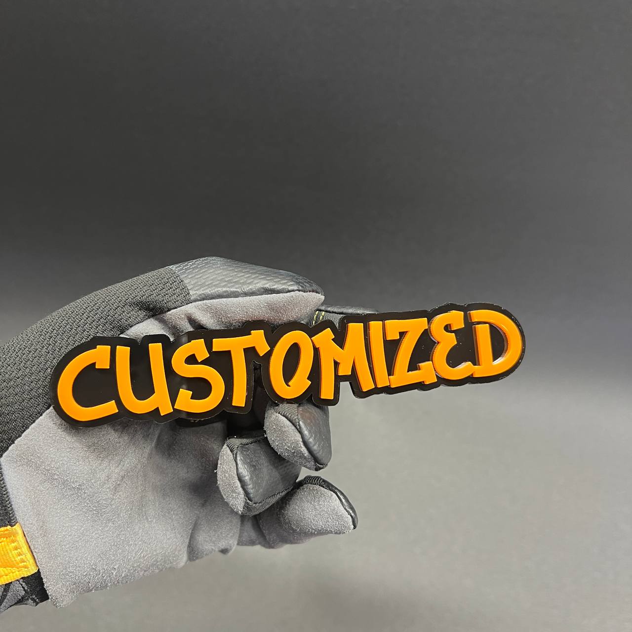 Personalized car badge with bold graffiti lettering and layered design.