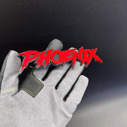 Red Phoenix text badge with layered black automotive-style backing